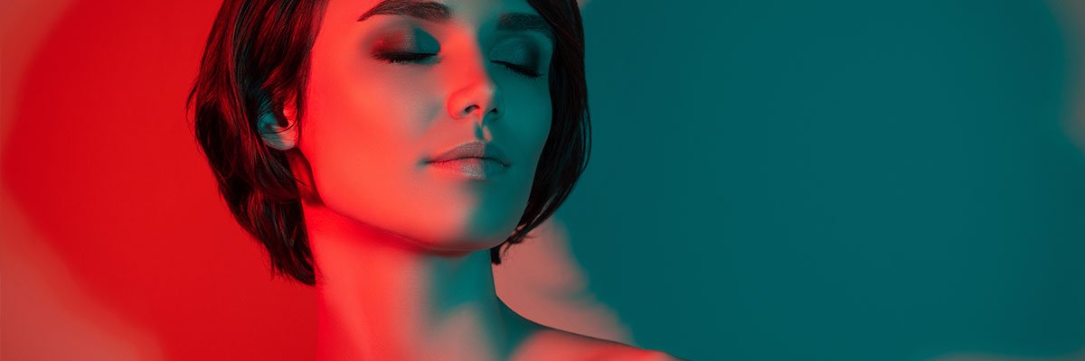 Woman undergoing a red light therapy session at Above & Beyond Wellness Spa